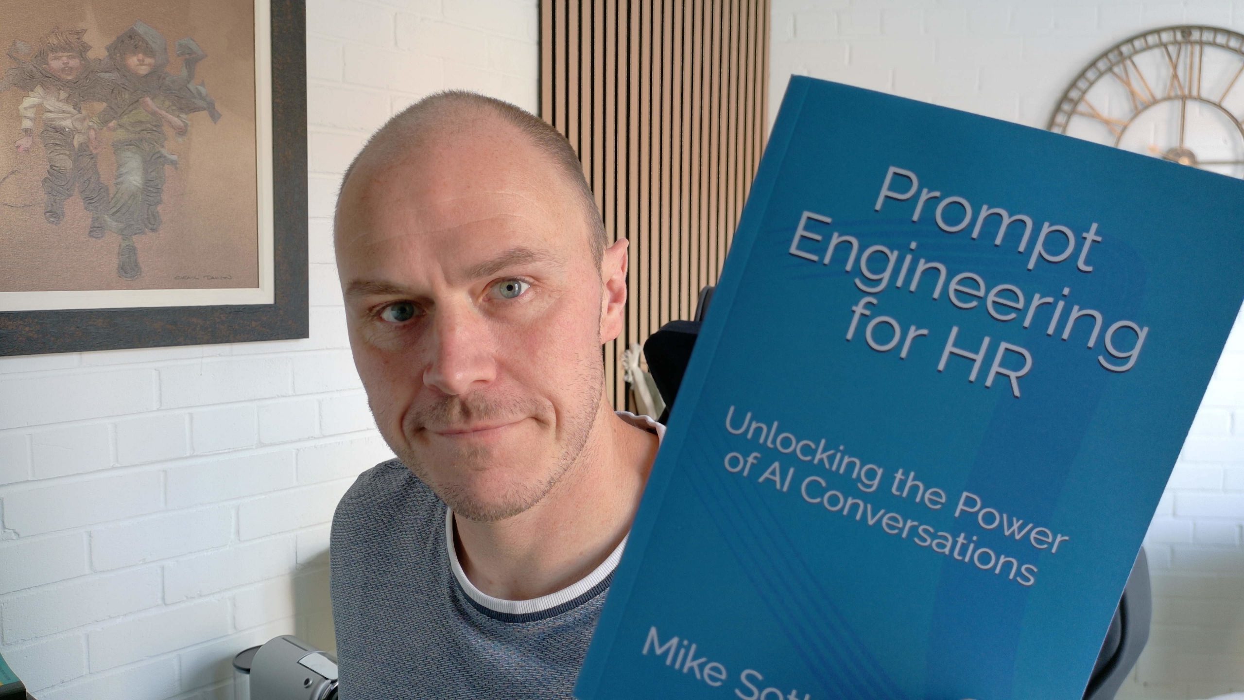 Image of mike sothern holding his new HR AI book, Prompt engineering for HR
